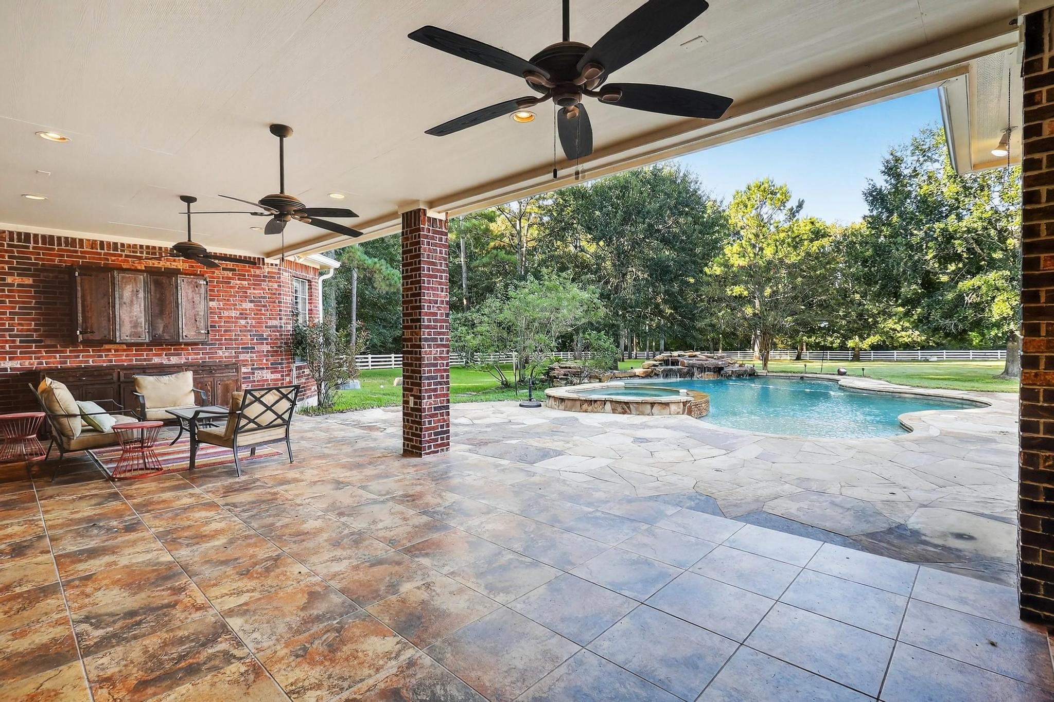 420 Whispering Meadow Magnolia, TX 77355 - Photo 40 of 44 a swimming pool with a lawn chairs and couches