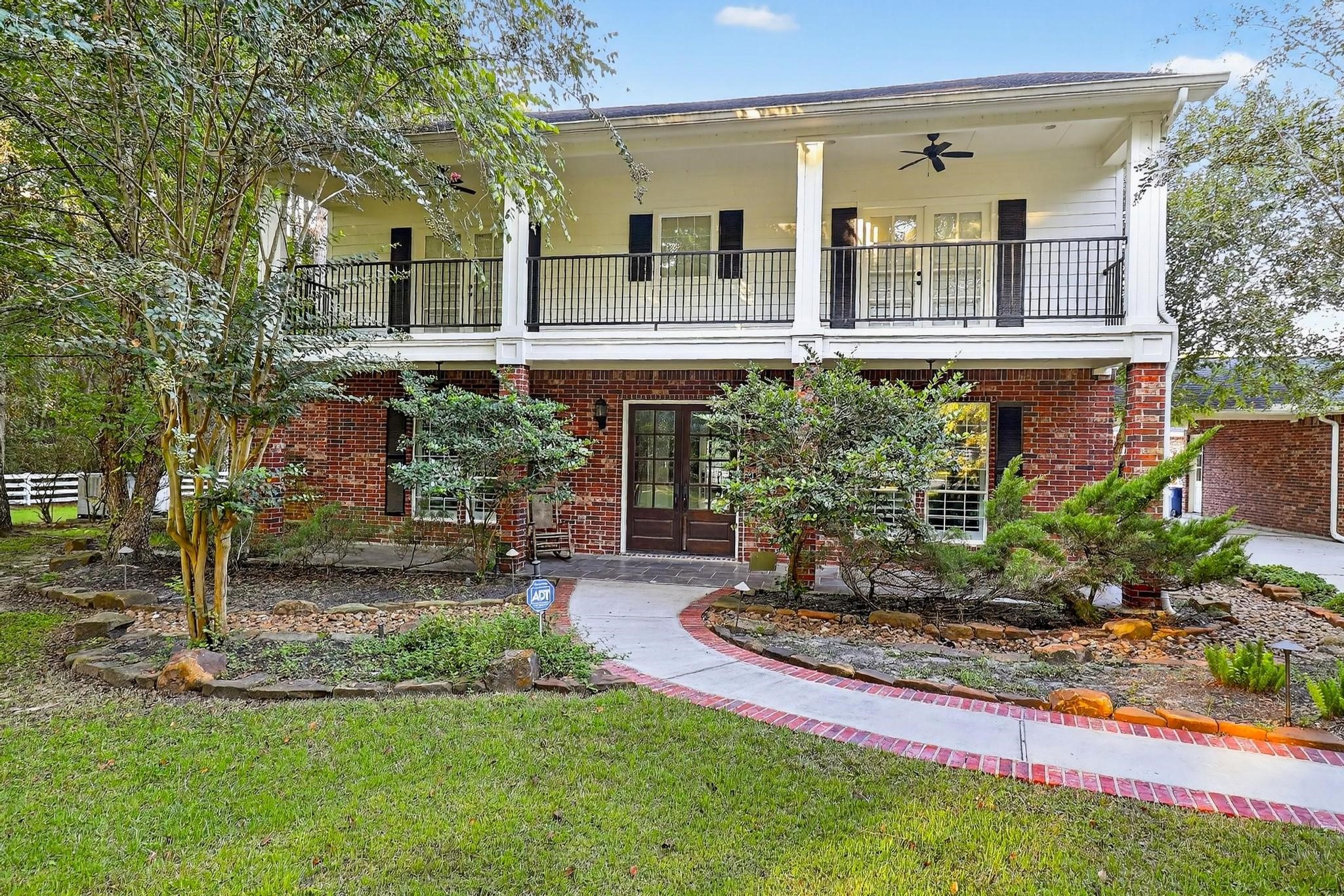 420 Whispering Meadow Magnolia, TX 77355 - Photo 4 of 44 a front view of a house with garden