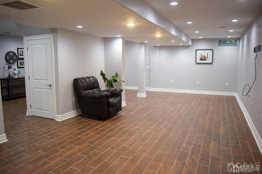 45 Stratton Road Old Bridge, NJ 07747 - Photo 17 of 19 an empty room with wooden floor and windows