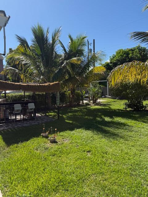 5409 Buchanan Road Delray Beach, FL 33484 - Photo 22 of 25 a front view of a house with swimming pool having outdoor seating