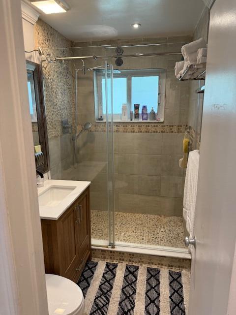5409 Buchanan Road Delray Beach, FL 33484 - Photo 8 of 25 a bathroom with a sink a toilet a mirror and shower