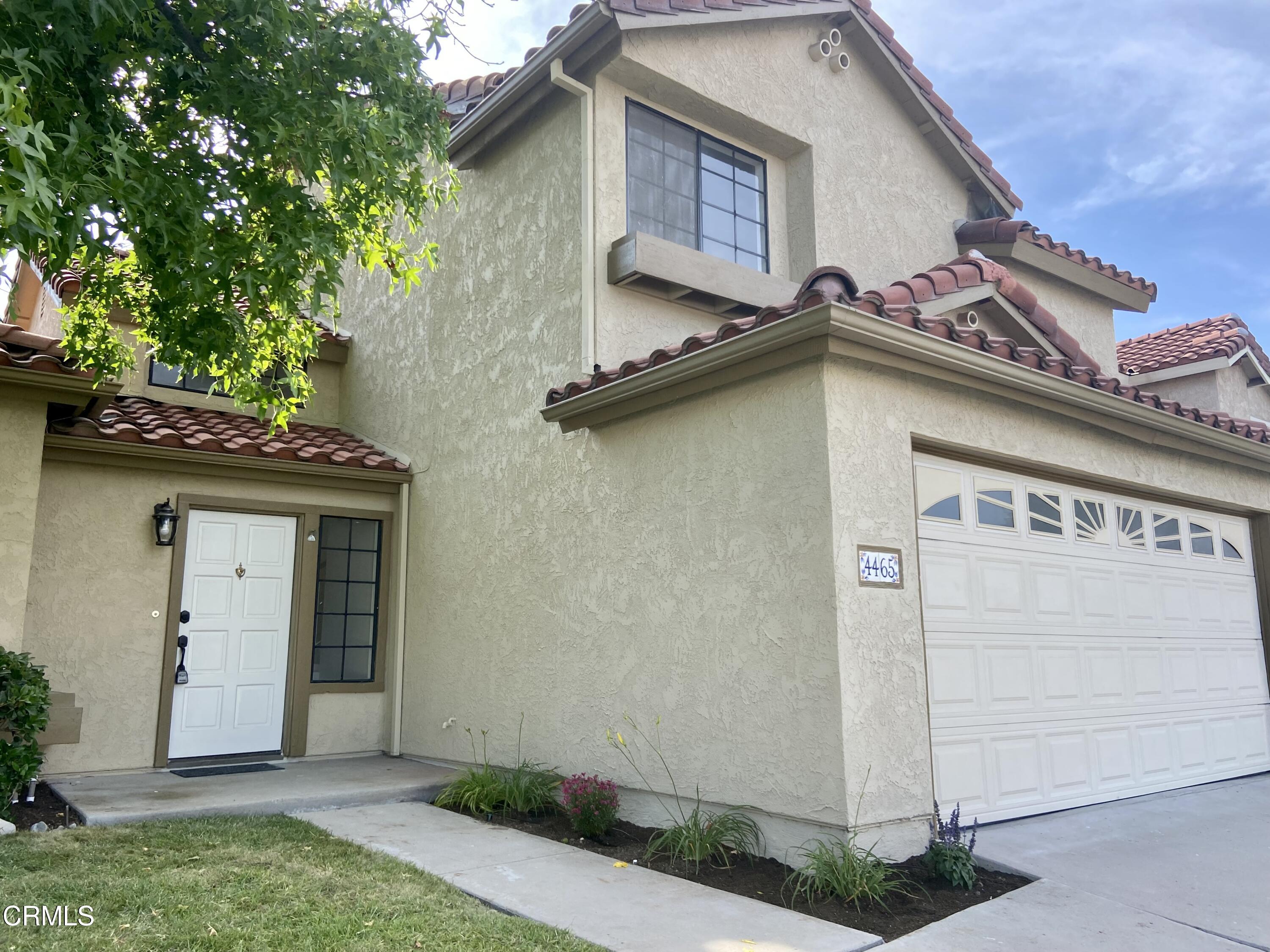 4465 Pine Ridge Court Moorpark, CA 93021 - Photo 1 of 22 a house with a clock on the side of it