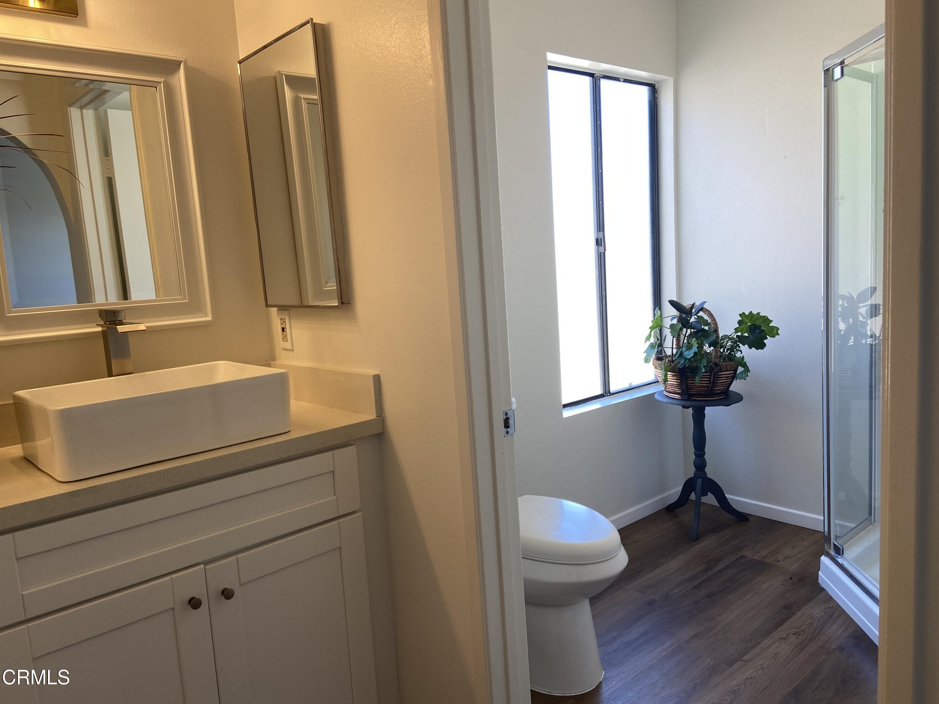 4465 Pine Ridge Court Moorpark, CA 93021 - Photo 11 of 22 a bathroom with a toilet a sink and mirror