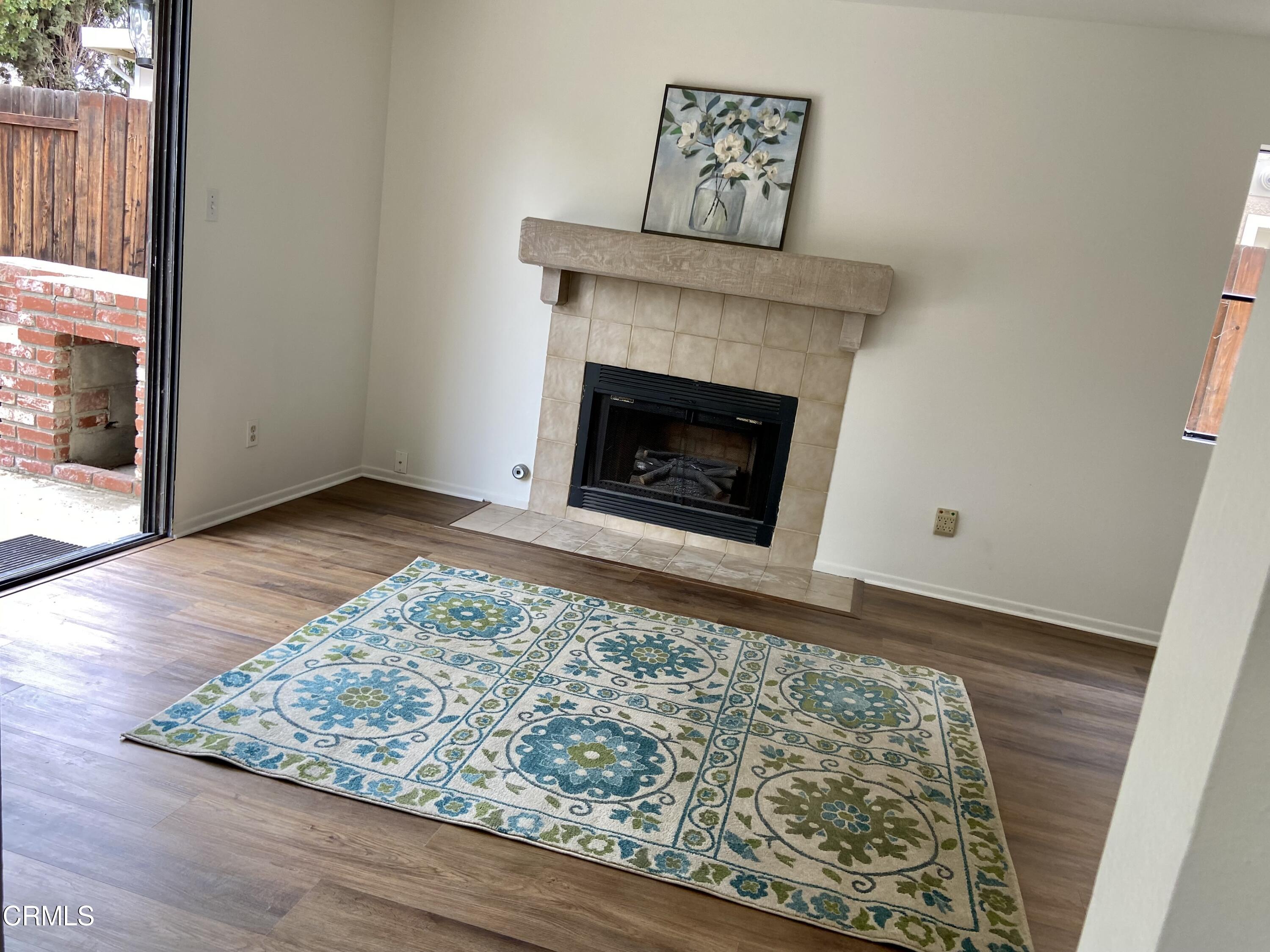 4465 Pine Ridge Court Moorpark, CA 93021 - Photo 17 of 22 a view of an empty room with wooden floor and a fireplace