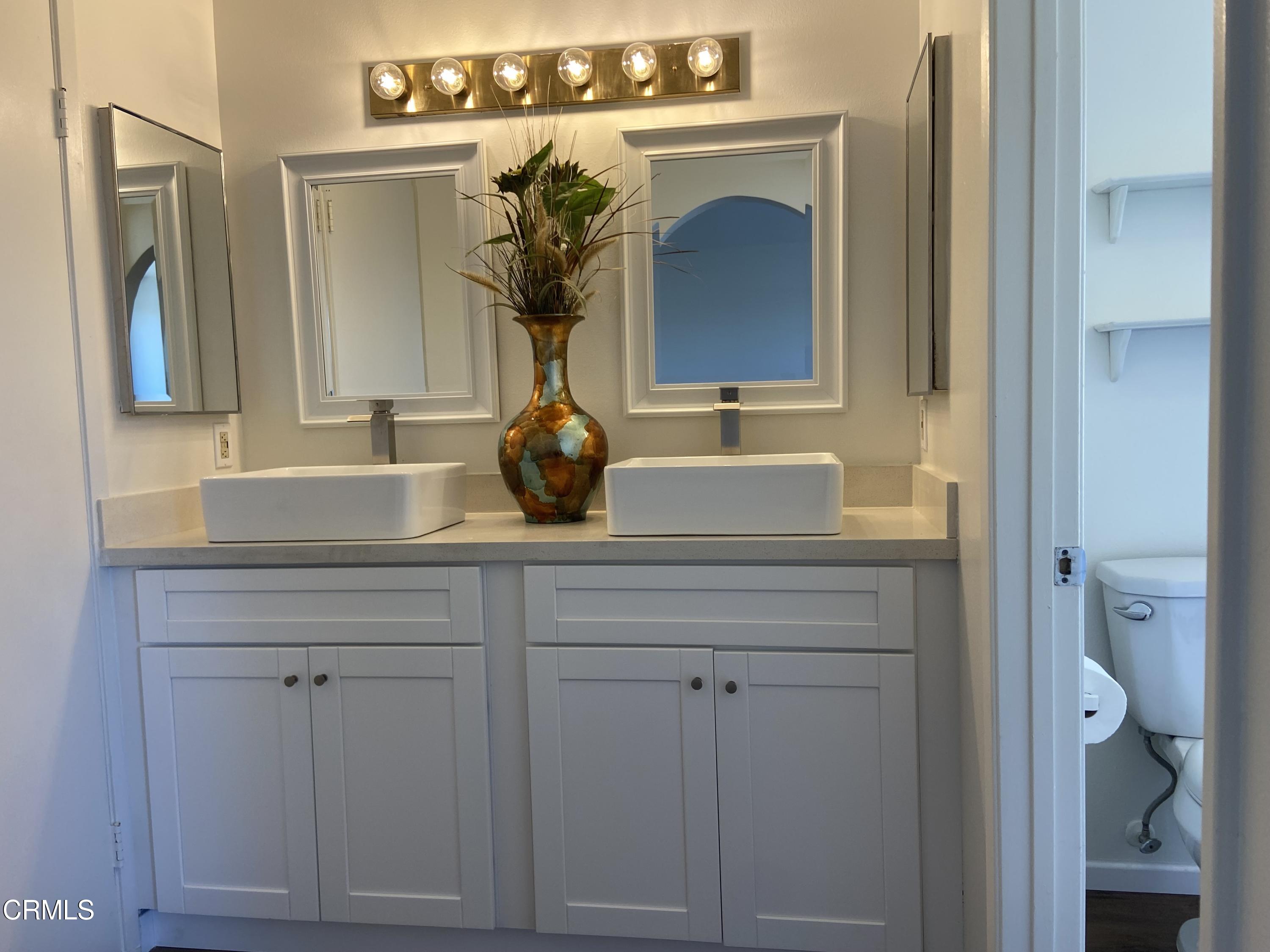 4465 Pine Ridge Court Moorpark, CA 93021 - Photo 9 of 22 a bathroom with a sink and a mirror