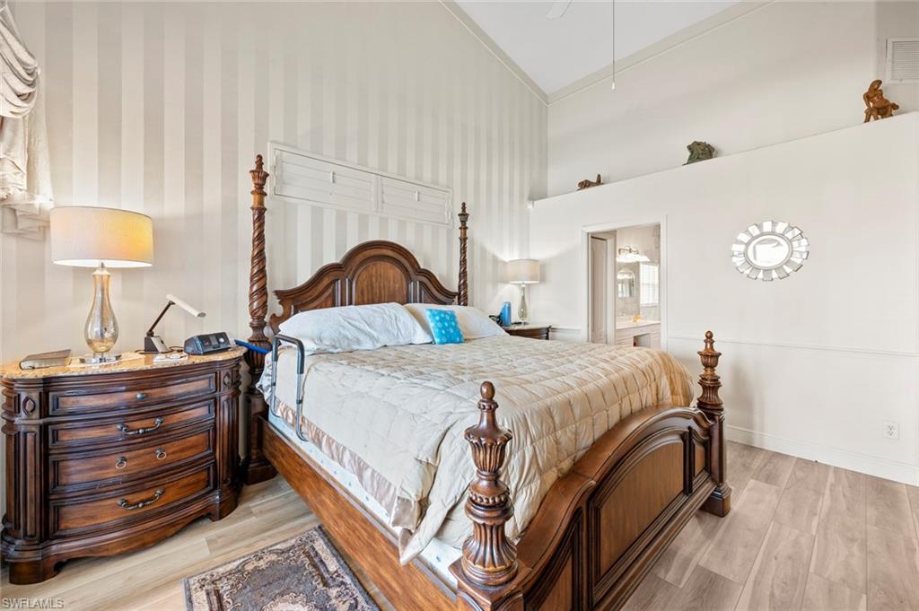 20810 Rivers Ford Estero, FL 33928 - Photo 25 of 49 a bedroom with a bed and a lamp