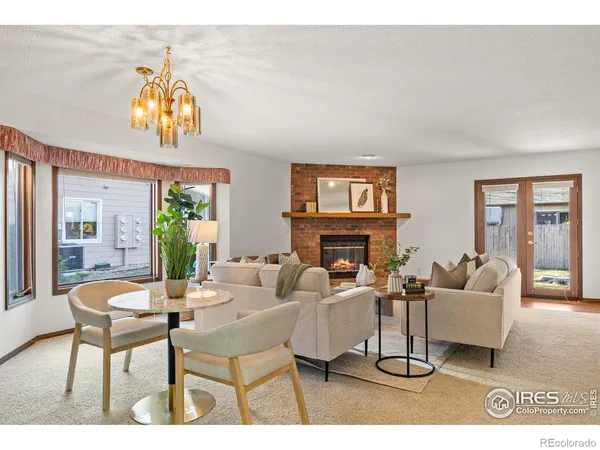 a living room with furniture a fireplace and a dining table
