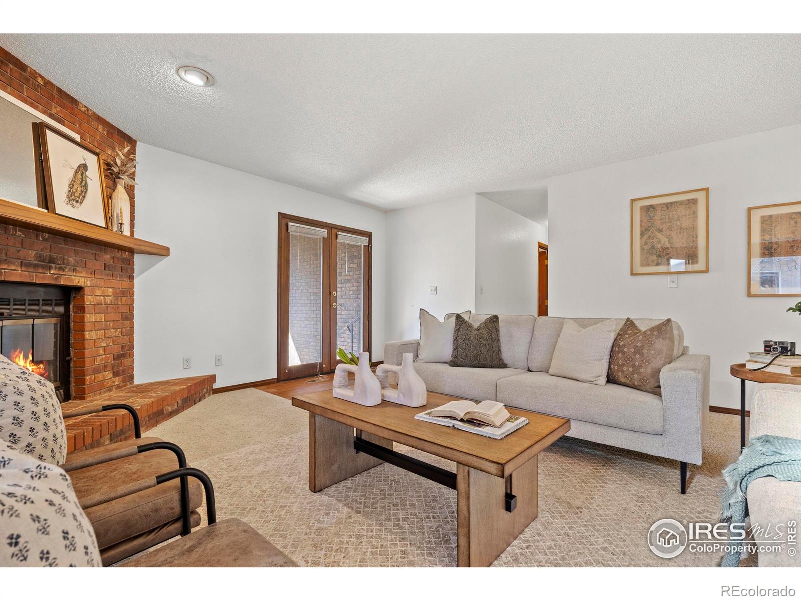 903 Conifer Court Windsor, CO 80550 - Photo 20 of 33 a living room with furniture a flat screen tv and a fireplace