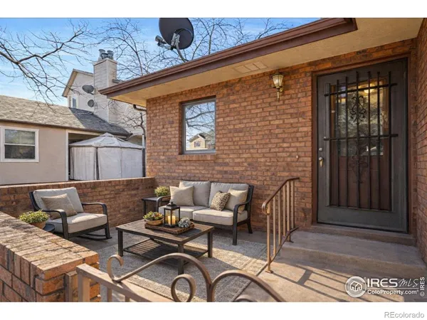 a view of a patio with couches and a table and chairs with wooden floor