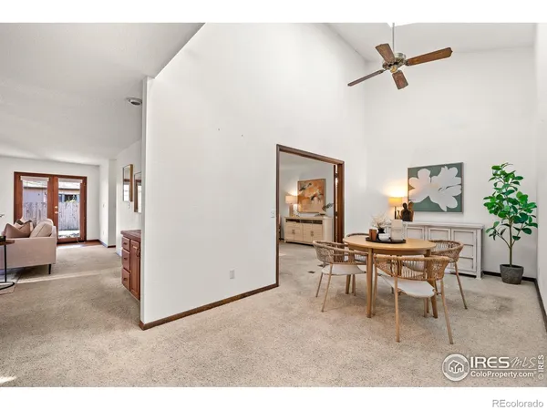 a living room with furniture a rug and a ceiling fan