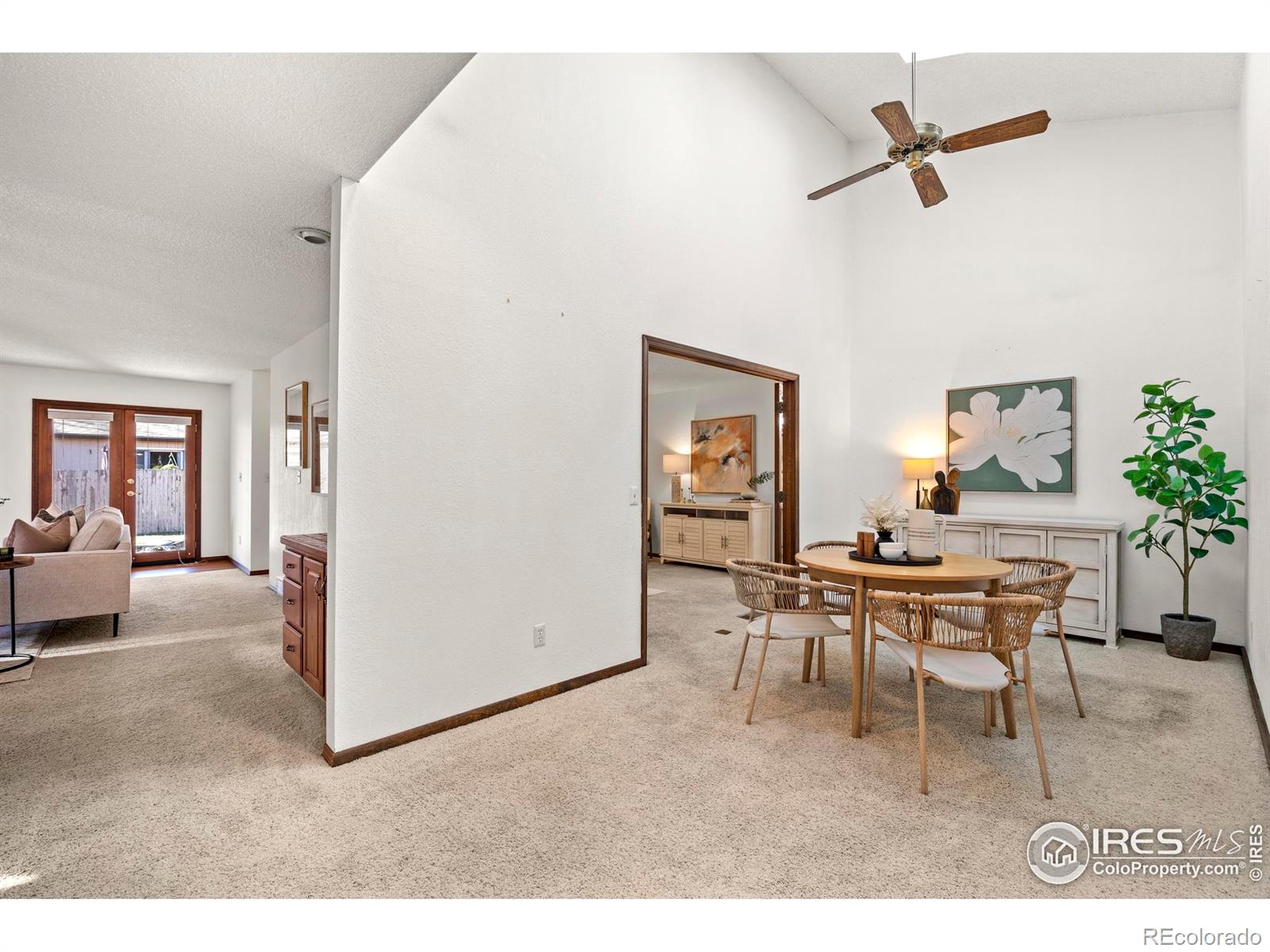 903 Conifer Court Windsor, CO 80550 - Photo 7 of 33 a living room with furniture a rug and a ceiling fan