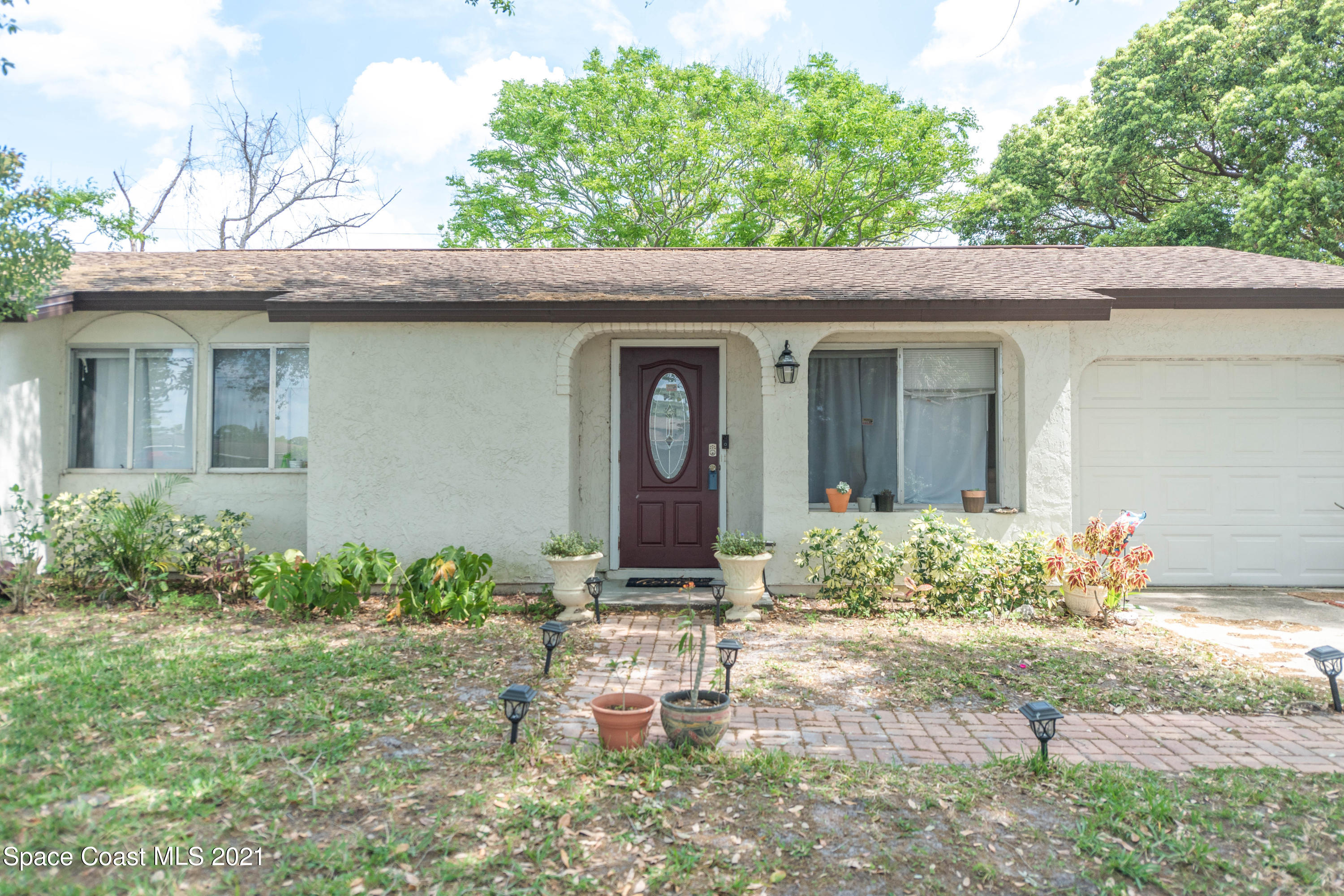 237 Chase Road Cocoa, FL 32927 - Photo 2 of 20 a front view of a house with garden