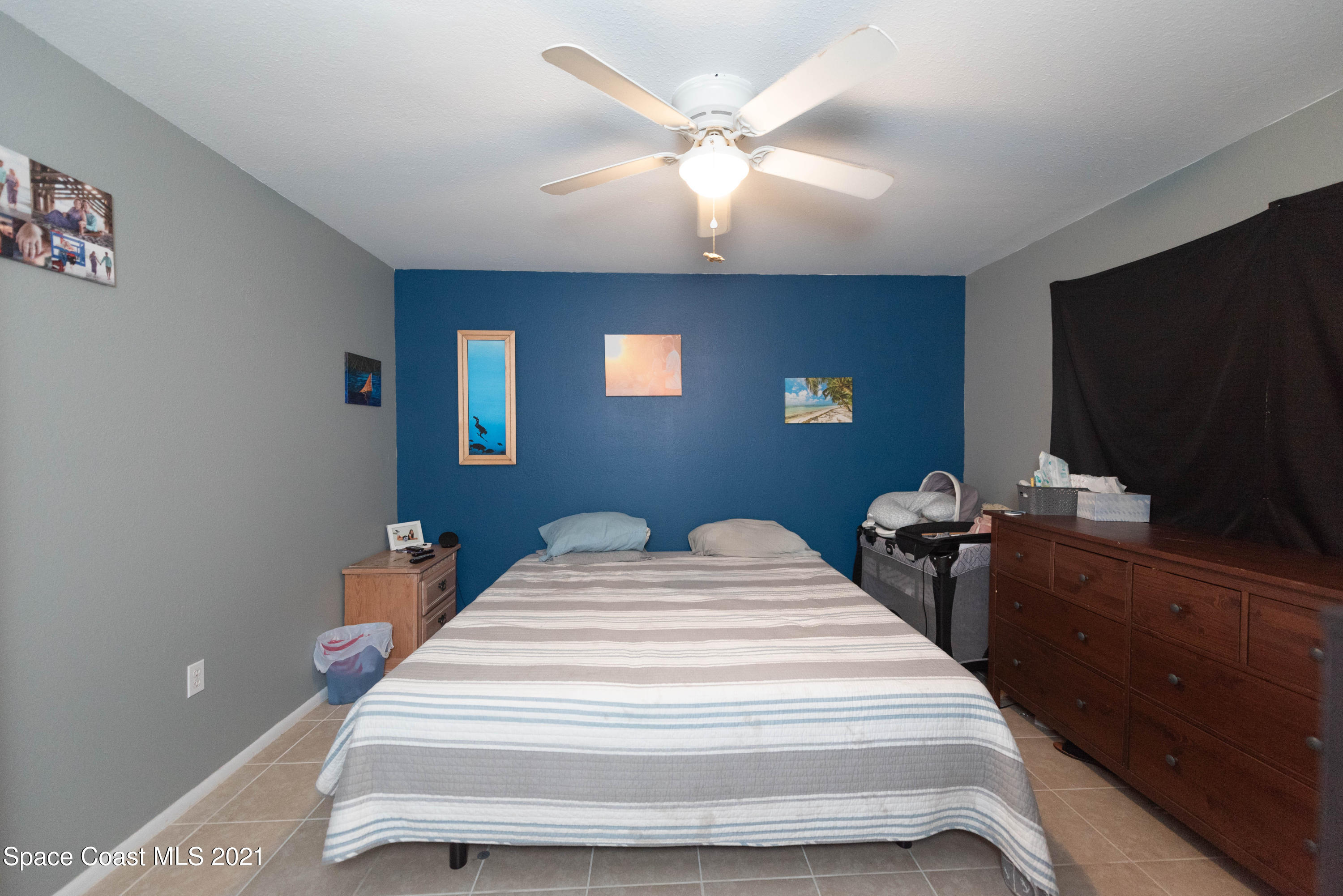 237 Chase Road Cocoa, FL 32927 - Photo 11 of 20 a bedroom with bed and a flat screen tv