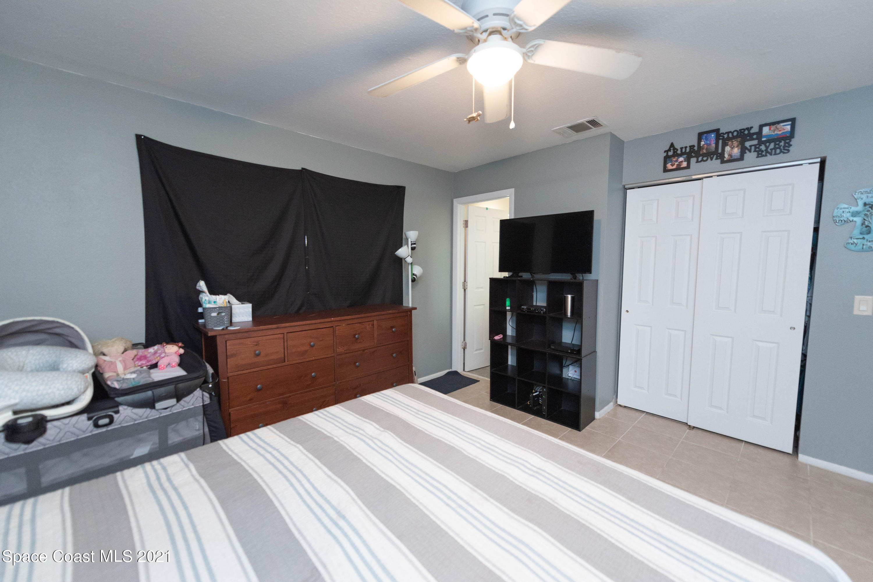 237 Chase Road Cocoa, FL 32927 - Photo 12 of 20 a bedroom with a bed and a television