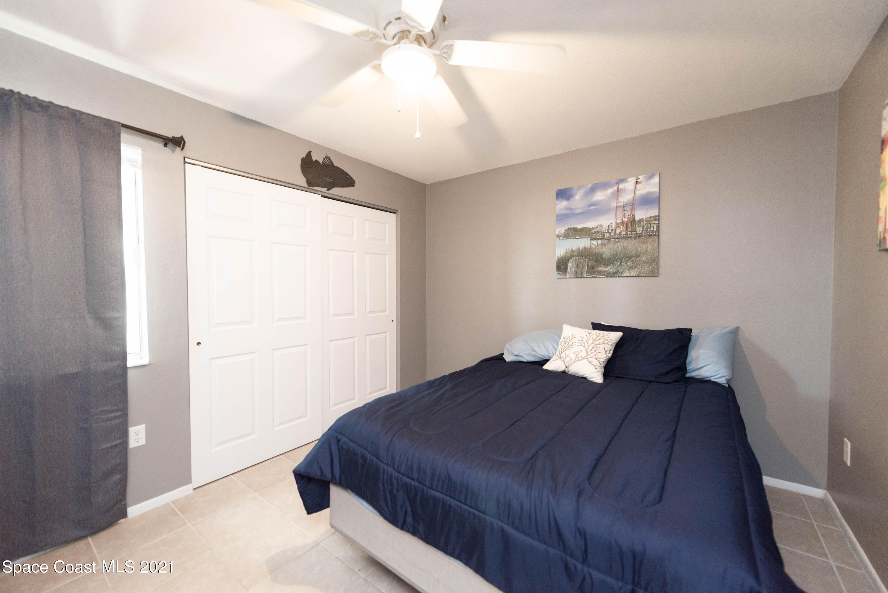 237 Chase Road Cocoa, FL 32927 - Photo 15 of 20 a bedroom with a bed and a painting on the wall