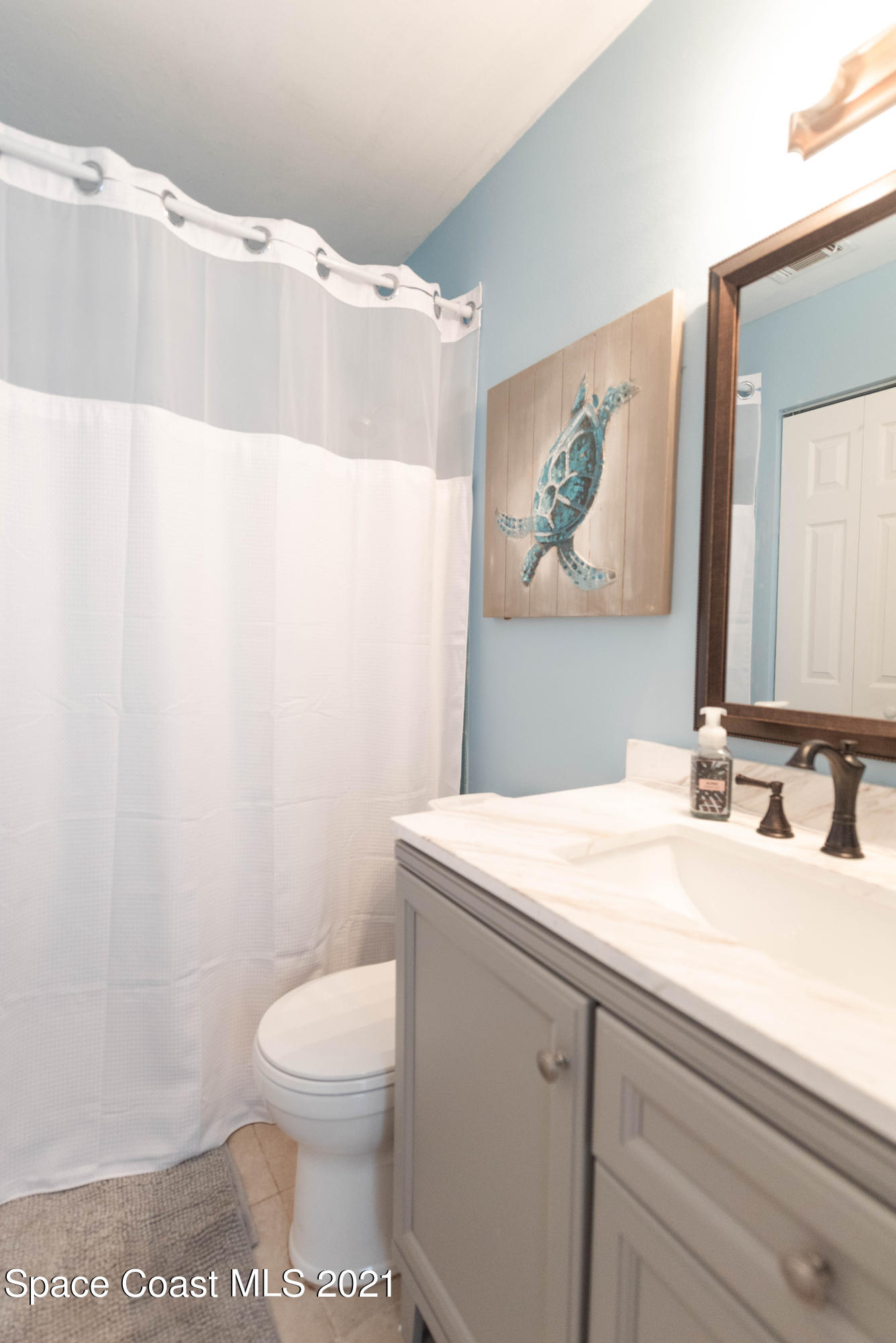 237 Chase Road Cocoa, FL 32927 - Photo 16 of 20 a bathroom with a sink a toilet and a mirror
