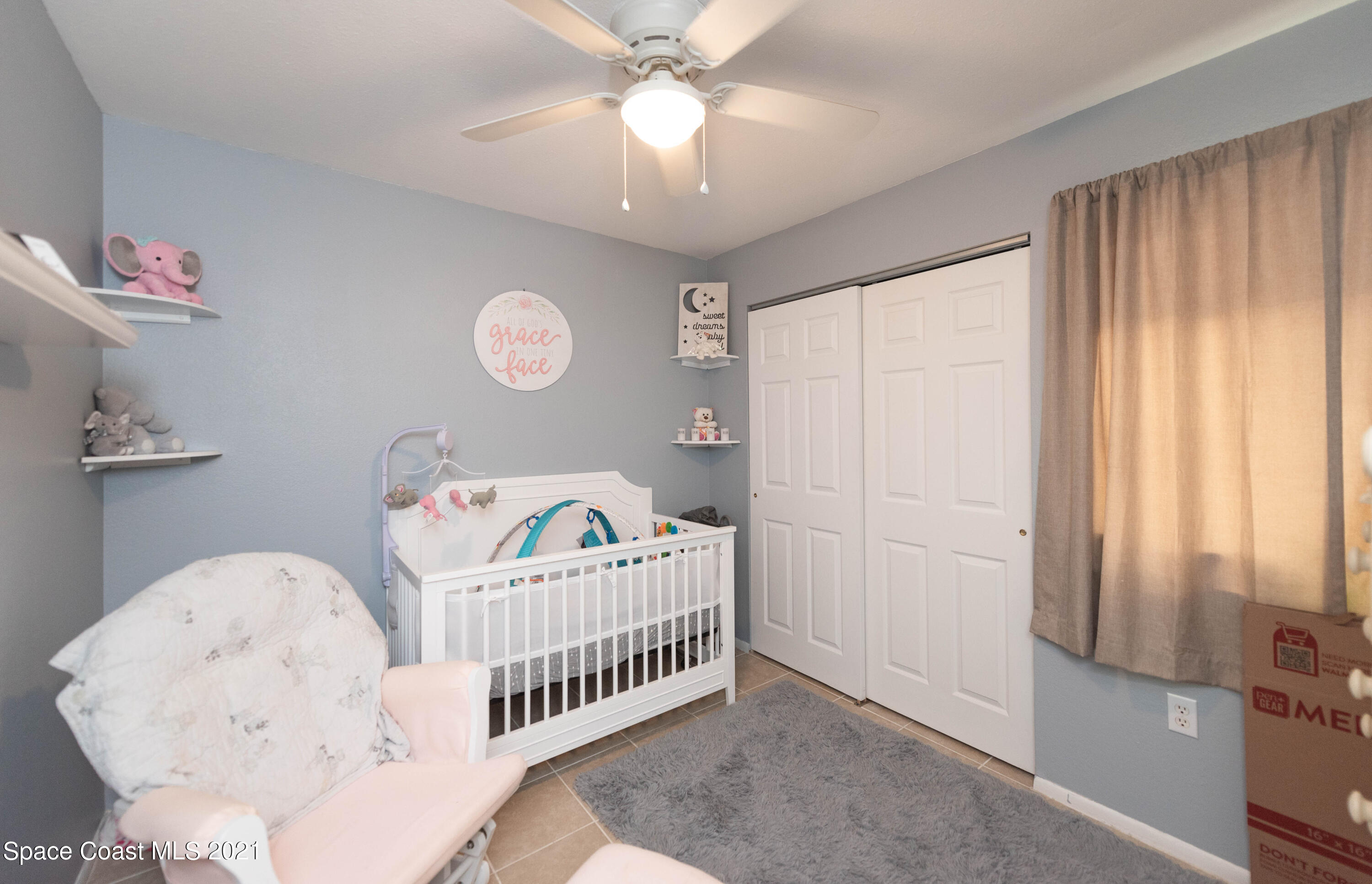 237 Chase Road Cocoa, FL 32927 - Photo 17 of 20 a bedroom with a bed and a window