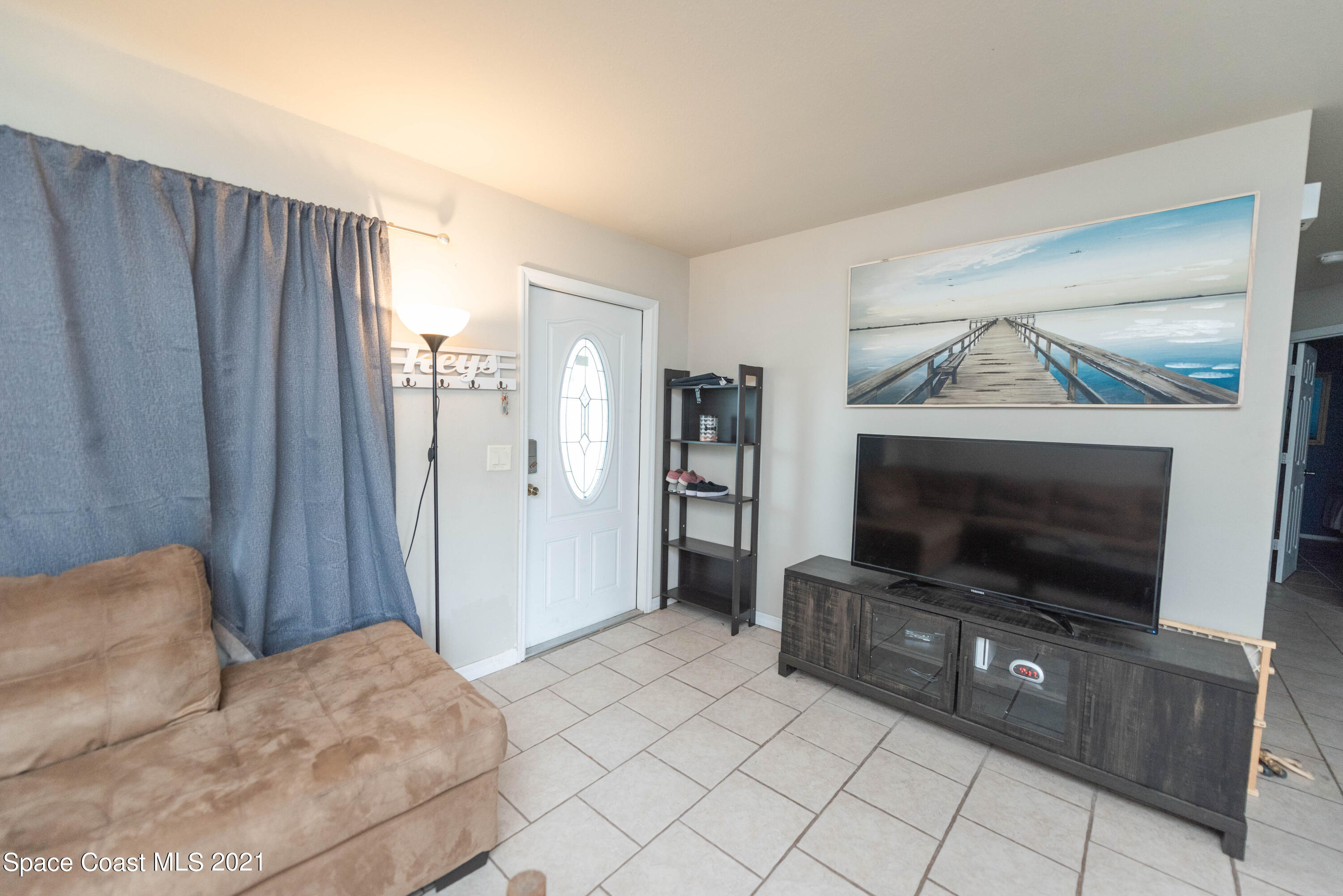 237 Chase Road Cocoa, FL 32927 - Photo 3 of 20 a living room with furniture and a flat screen tv