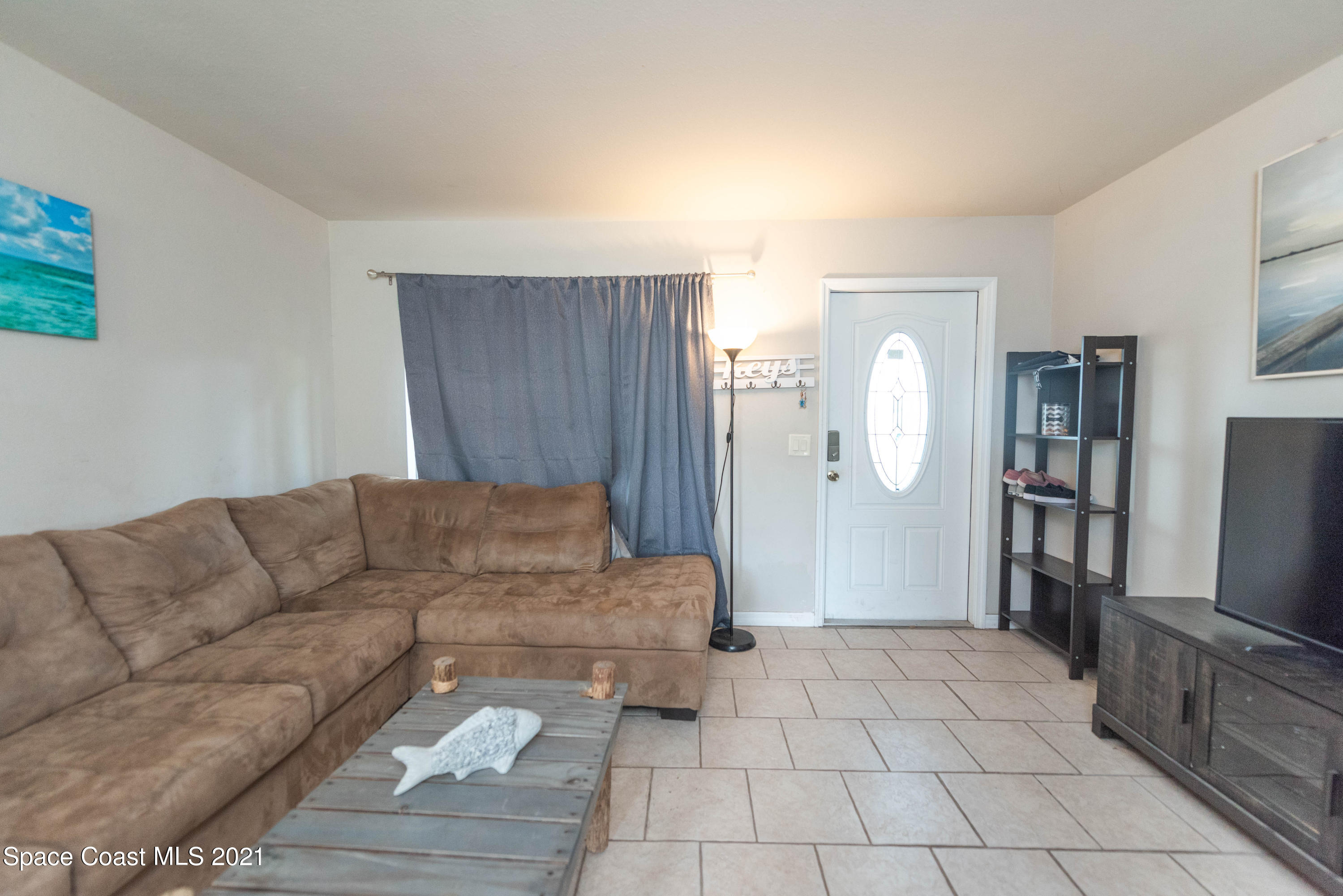 237 Chase Road Cocoa, FL 32927 - Photo 5 of 20 a living room with furniture and a flat screen tv