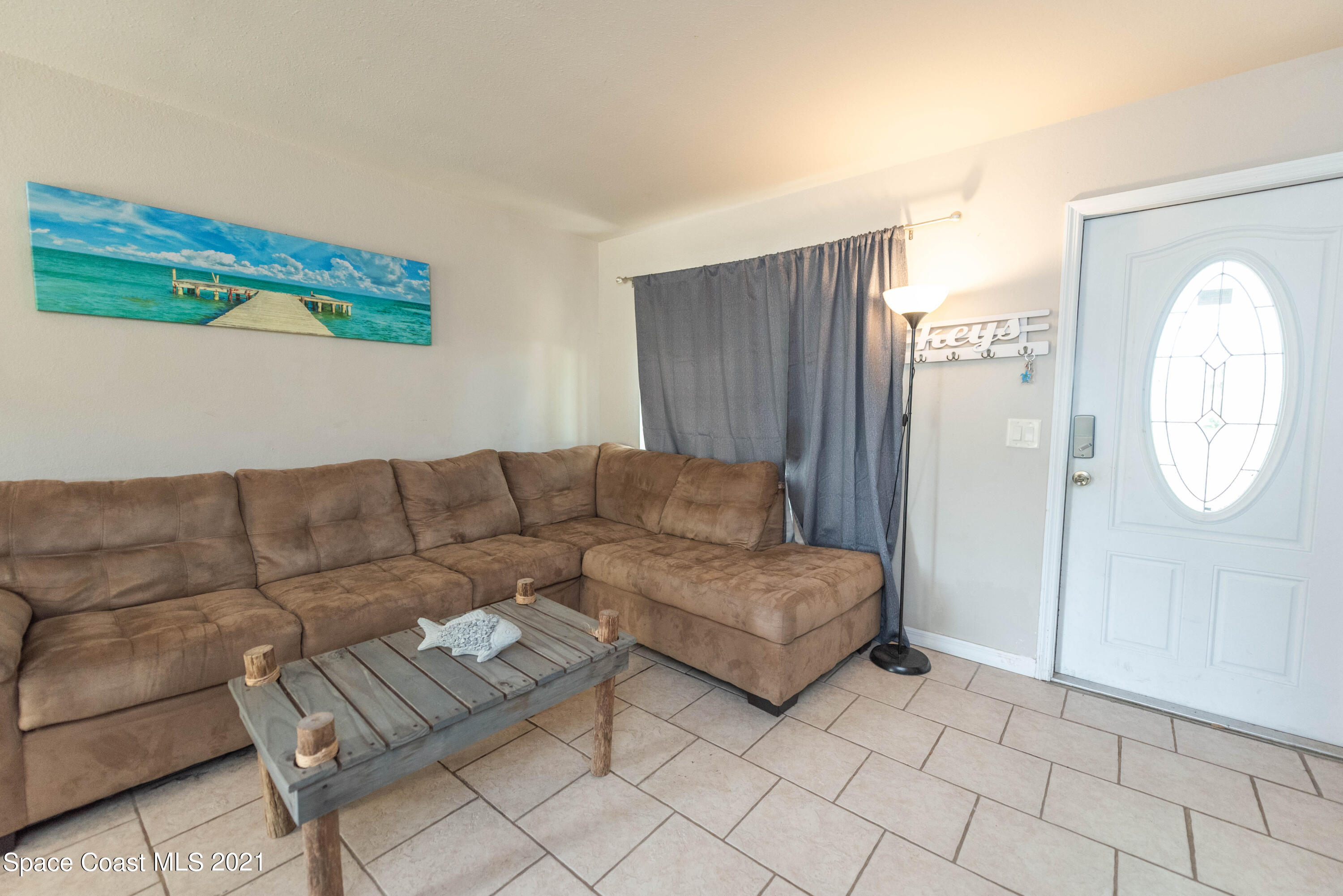 237 Chase Road Cocoa, FL 32927 - Photo 6 of 20 a living room with couches and a large window