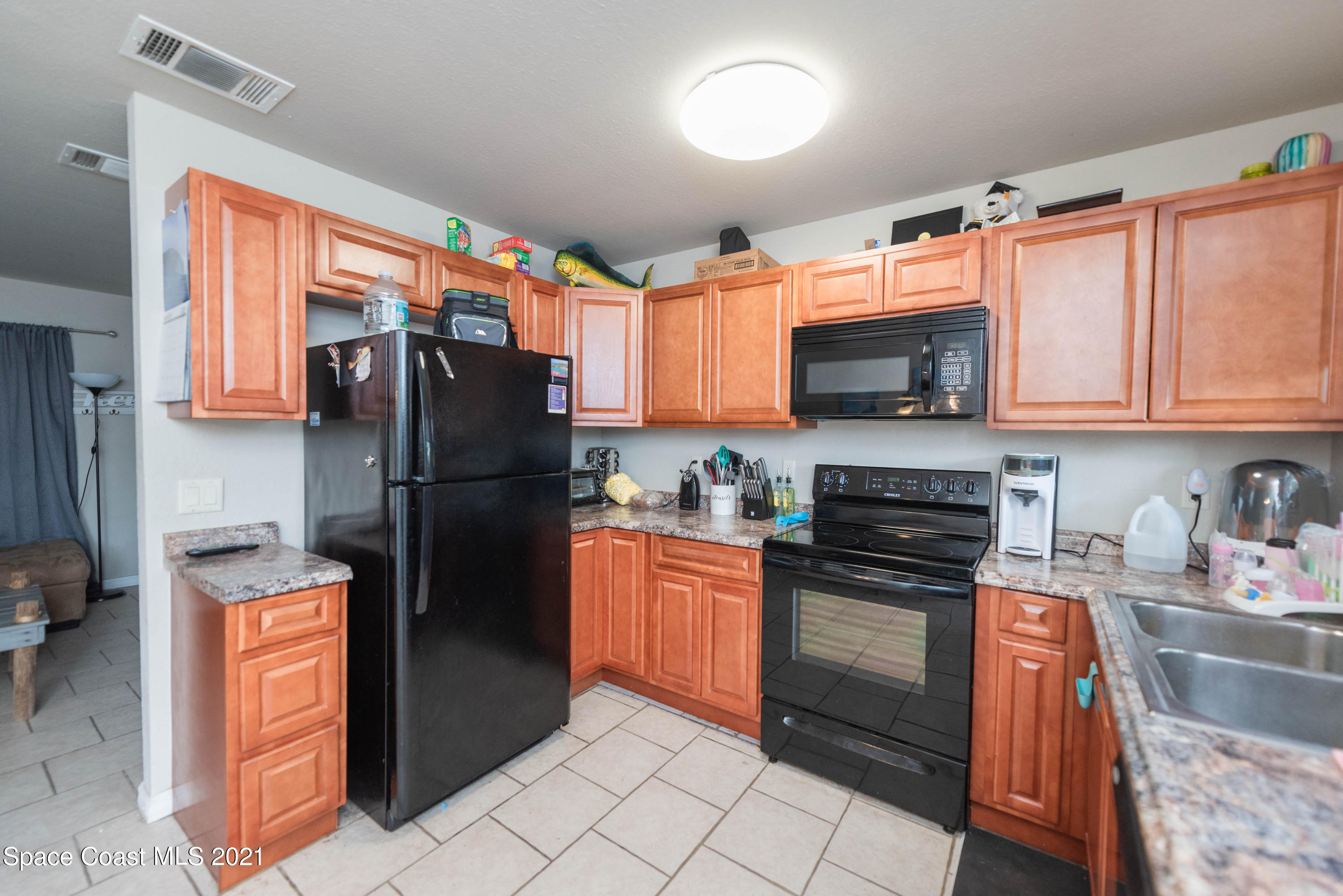 237 Chase Road Cocoa, FL 32927 - Photo 9 of 20 a kitchen with stainless steel appliances granite countertop a refrigerator stove and sink