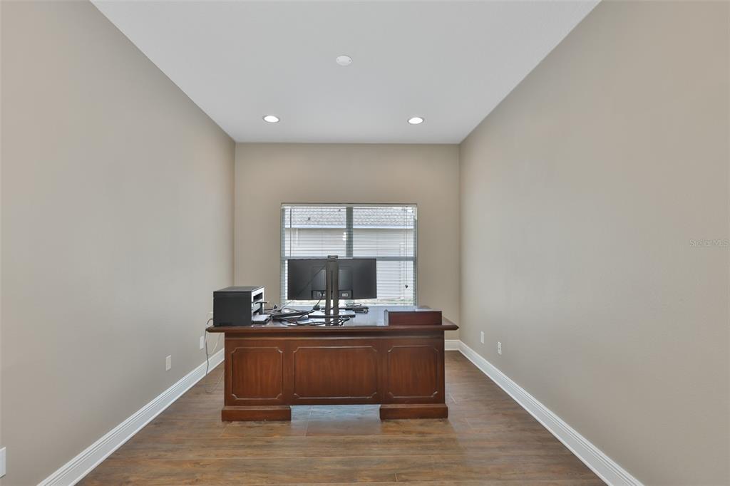 708 Coade Stone Drive Seffner, FL 33584 - Photo 7 of 48 a room with wooden floor and white walls