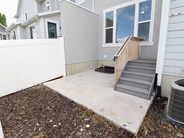 8240 Cascade Vw Way Magna, UT 84044 - Photo 12 of 18 Entrance to property featuring a patio area and stucco siding