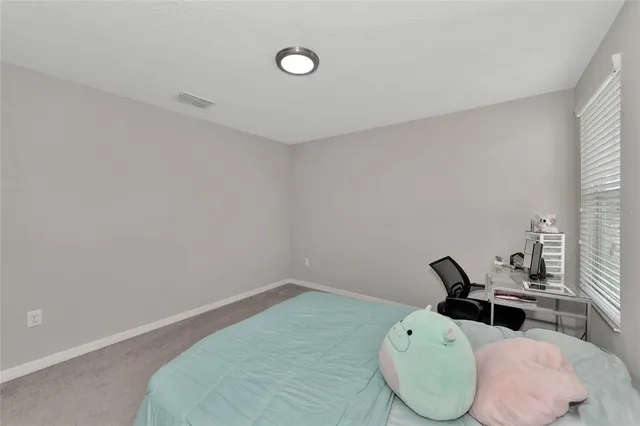 a bedroom with a bed and a night stand