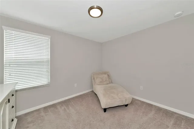 a bedroom with a bed and flat tv screen on the dresser
