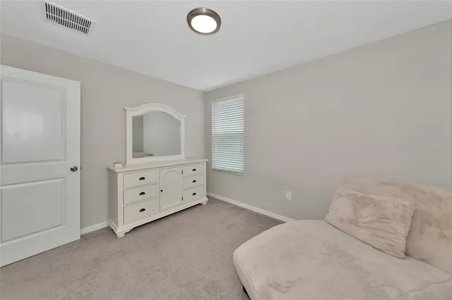 a bedroom with a bed and a table