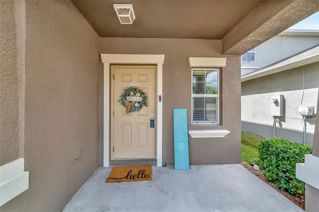 a living room with furniture and floor to ceiling window