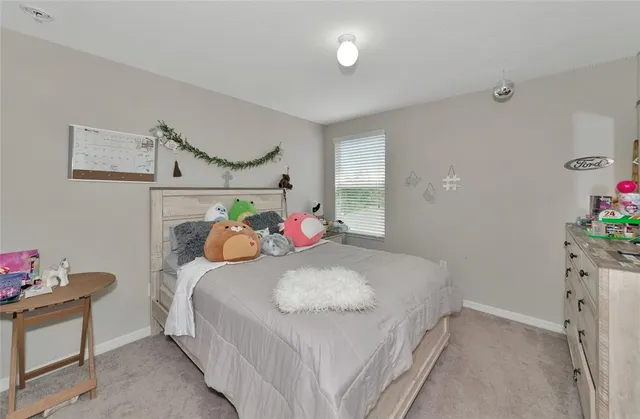 a bedroom with bed and a ceiling fan