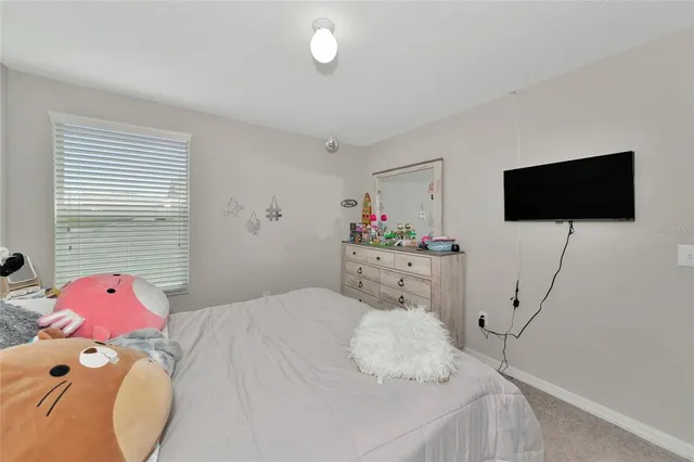 a bedroom with a bed and a ceiling fan