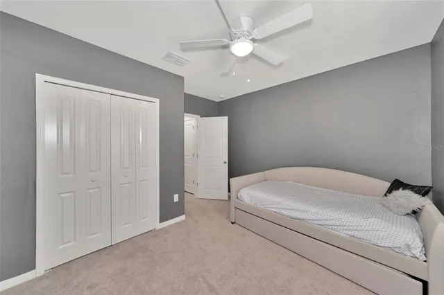 front view of house with a yard and potted plants
