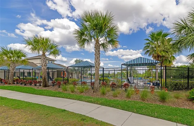 an aerial view of a house with a yard basket ball court and outdoor seating