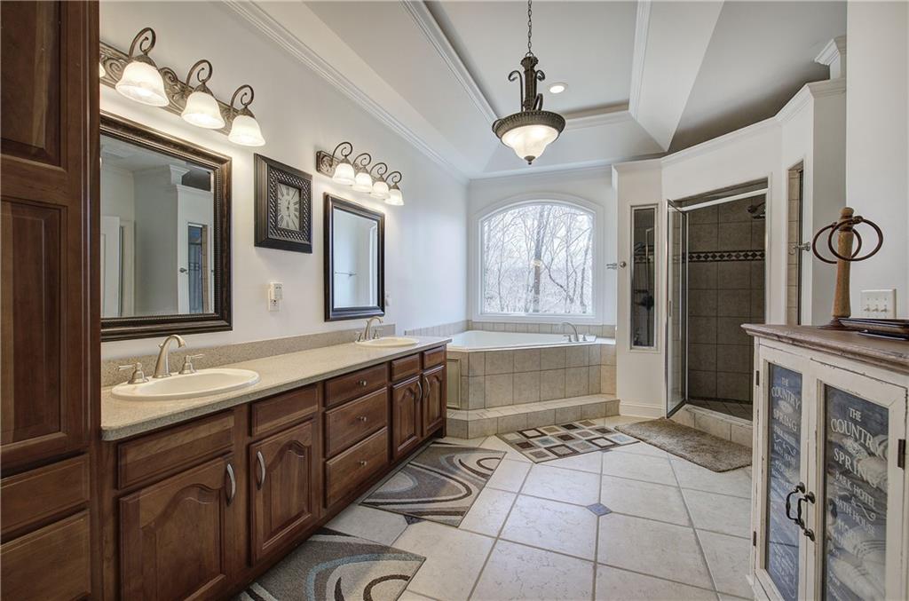 64 Fairview Court Jasper, GA 30143 - Photo 33 of 86 a spacious bathroom with a double vanity sink a mirror and a bathtub