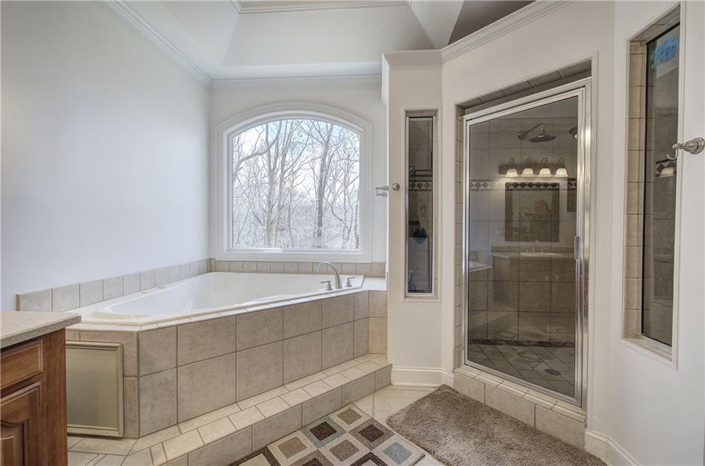 64 Fairview Court Jasper, GA 30143 - Photo 36 of 86 a spacious bathroom with a glass shower door and a bathtub