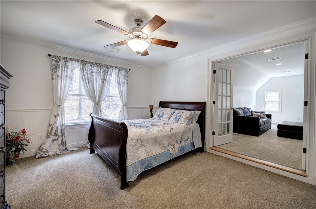 64 Fairview Court Jasper, GA 30143 - Photo 41 of 86 a spacious bedroom with a bed and a chandelier