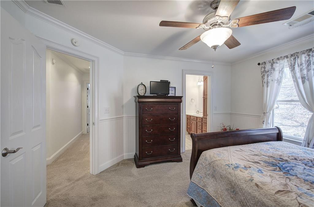 64 Fairview Court Jasper, GA 30143 - Photo 42 of 86 a bedroom with a bed and a chandelier