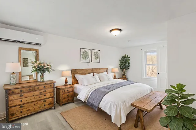 a bedroom with a bed and a dresser