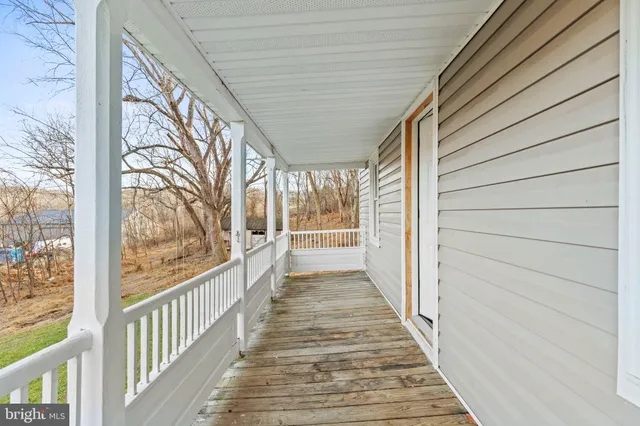 a view of a porch with wooden floor and outdoor space