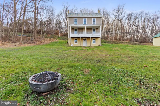 a view of a house with a backyard and a grill