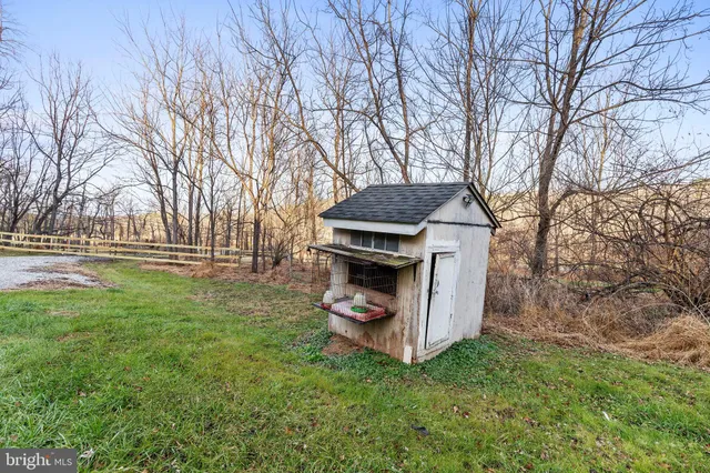 a view of a backyard with wooden fence