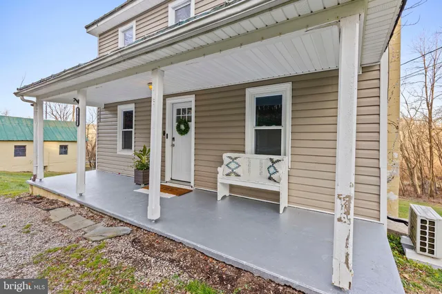a view of a patio with table and chairs with wooden floor and fence