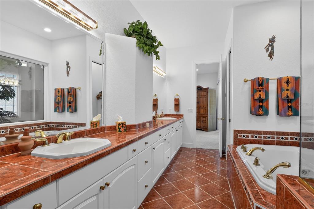2968 Plantation Road Winter Haven, FL 33884 - Photo 33 of 81 a spacious bathroom with a double vanity sink and a mirror