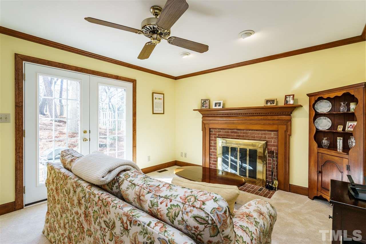 2212 Tyson Street Raleigh, NC 27612 - Photo 7 of 24 a bedroom with a bed and a fireplace