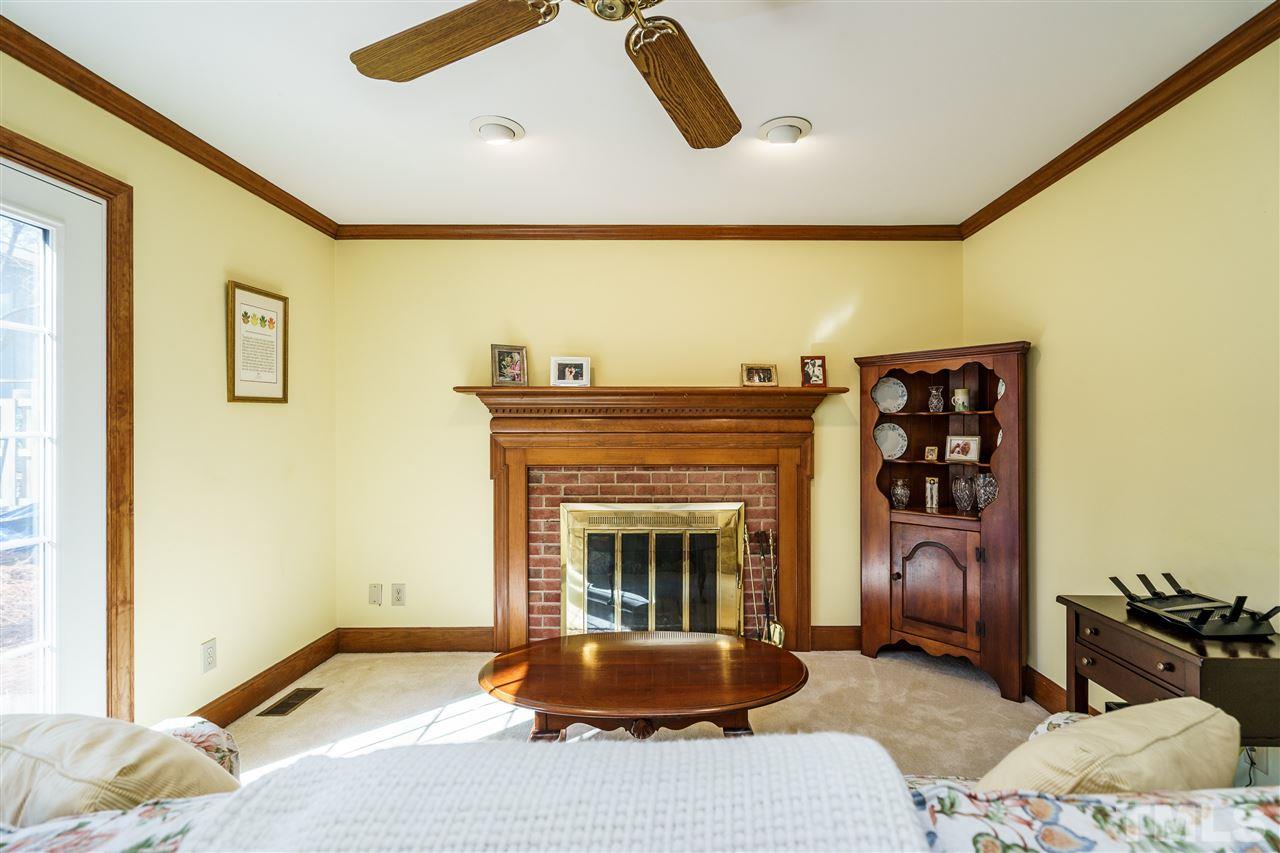 2212 Tyson Street Raleigh, NC 27612 - Photo 8 of 24 a living room with furniture and a fireplace