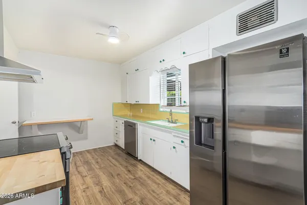 a kitchen with a refrigerator and sink