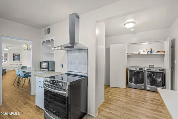 a kitchen with stainless steel appliances granite countertop a stove and a refrigerator