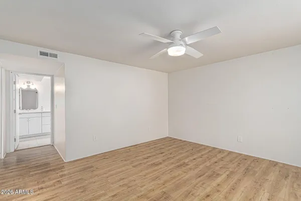 a view of empty room with wooden floor